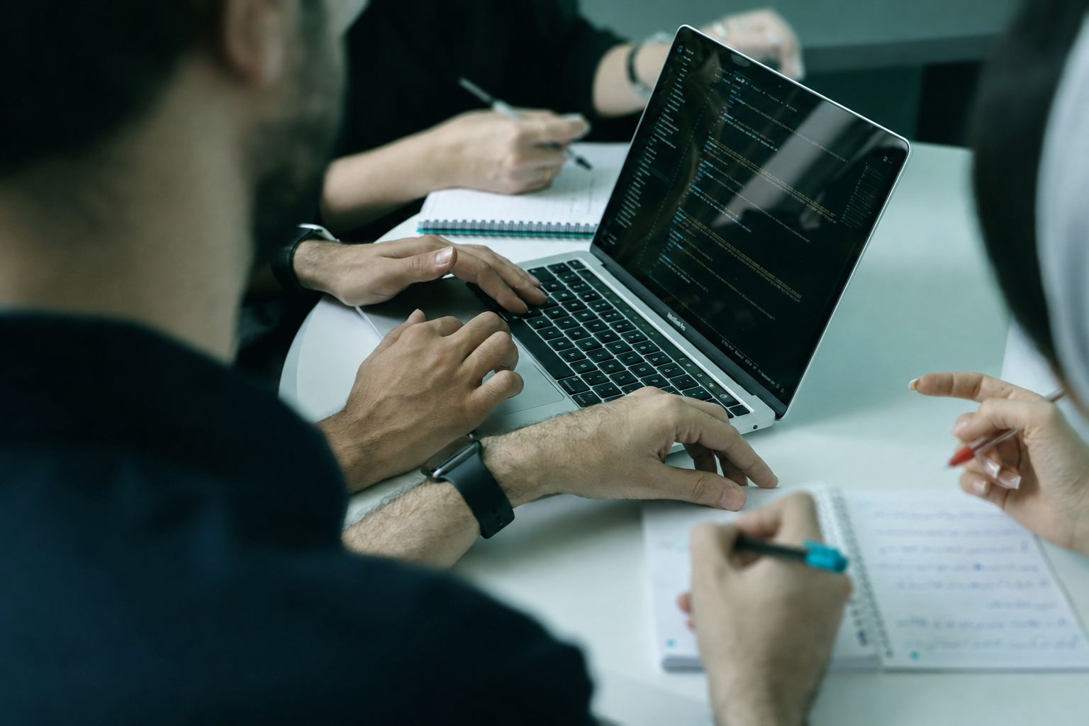 Two colleagues reviewing project plans during a meeting
